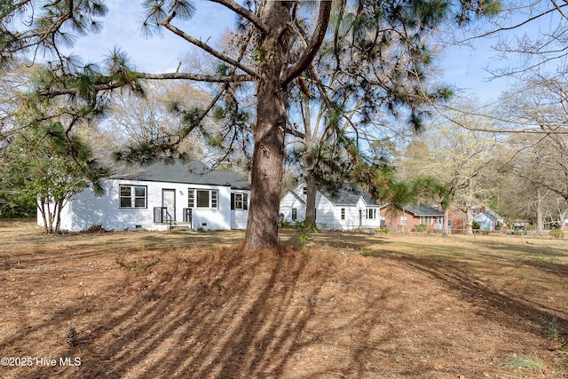 rear view of house featuring a shingled roof