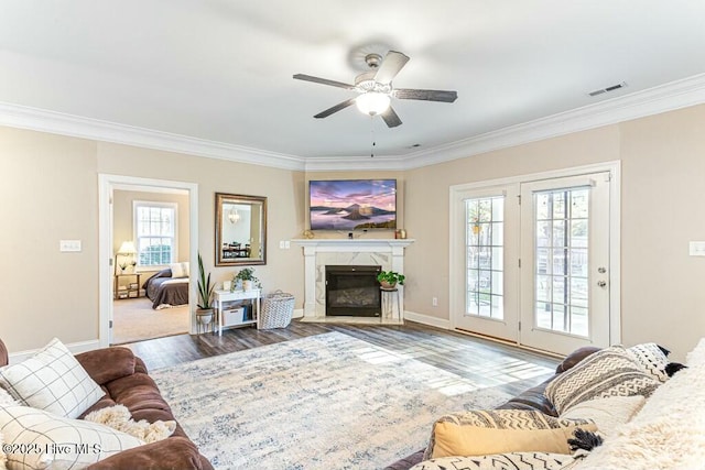 320 Thorne Rd, Pinehurst, NC 28374 - living room featuring ornamental molding, ceiling fan, baseboards, wood finished floors, and a fireplace