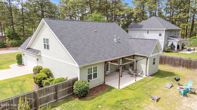 320 Thorne Rd, Pinehurst, NC 28374 - rear view of property with a garage, roof with shingles, concrete driveway, and a patio