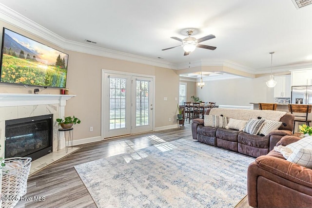 320 Thorne Rd, Pinehurst, NC 28374 - living area with ceiling fan, crown molding, baseboards, wood finished floors, and a high end fireplace