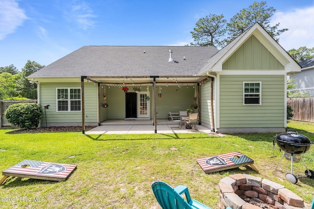 320 Thorne Rd, Pinehurst, NC 28374 - rear view of house featuring an outdoor fire pit, board and batten siding, a patio, and a shingled roof