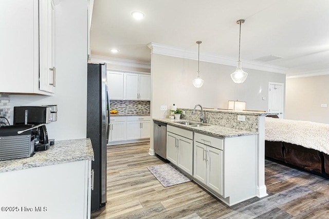 320 Thorne Rd, Pinehurst, NC 28374 - kitchen featuring stainless steel appliances, a sink, light wood finished floors, tasteful backsplash, and ornamental molding