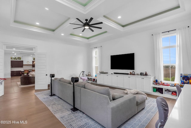 living area featuring ceiling fan, plenty of natural light, and wood finished floors