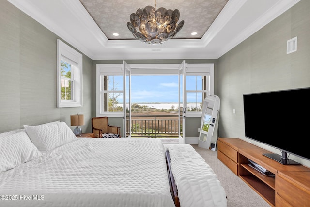 bedroom with ornamental molding, a tray ceiling, access to outside, and carpet floors