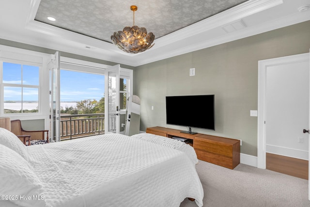 carpeted bedroom featuring a chandelier, access to exterior, baseboards, and a raised ceiling