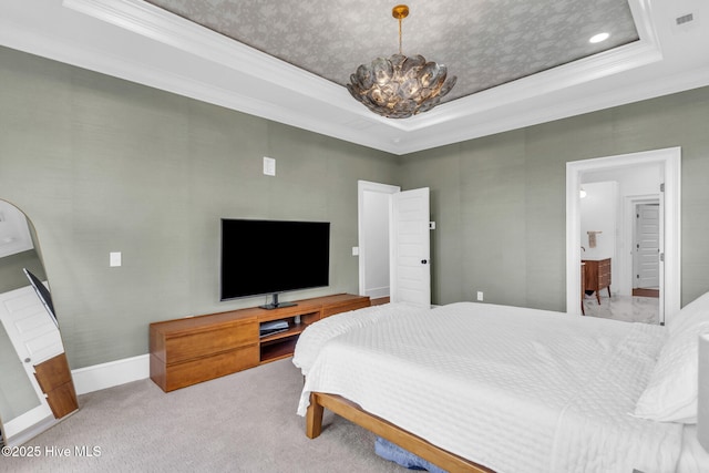 carpeted bedroom featuring ornamental molding, a tray ceiling, and a chandelier
