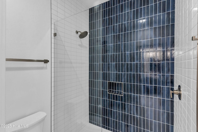 full bath with toilet and a tile shower