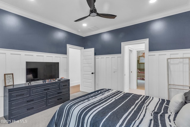 bedroom featuring ornamental molding, recessed lighting, a wainscoted wall, ceiling fan, and a decorative wall