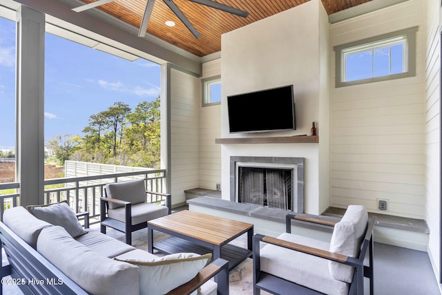 exterior space with wooden ceiling, a ceiling fan, wooden walls, and an outdoor fireplace