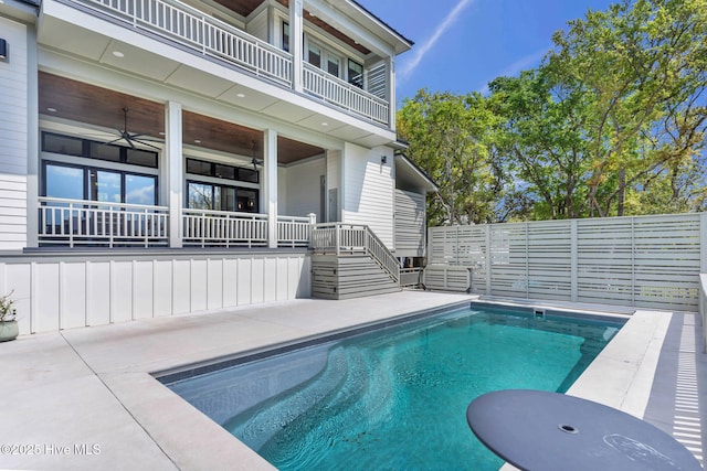 view of pool with a fenced in pool, a patio area, a fenced backyard, and a ceiling fan