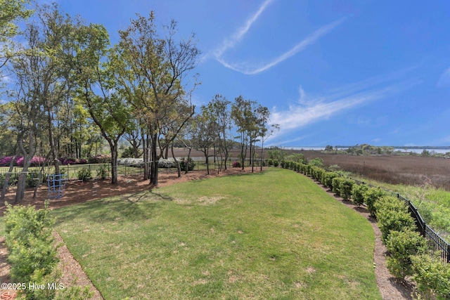 view of yard featuring a rural view and fence