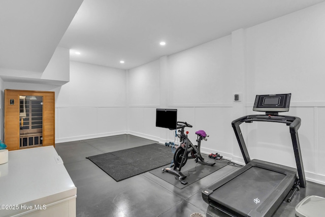 workout area featuring a decorative wall and recessed lighting