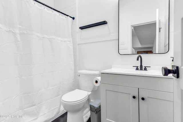 bathroom with toilet, vanity, and a shower with shower curtain