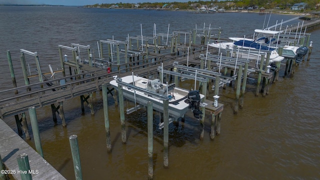 dock area with boat lift and a water view