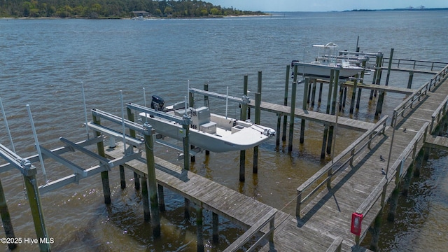 dock area featuring boat lift and a water view