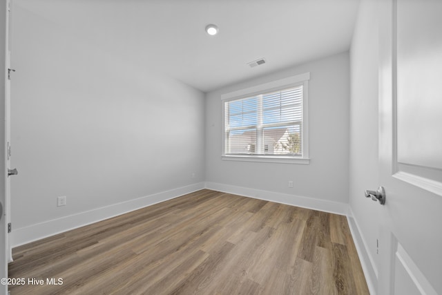 7801 Harrier Cir, Leland, NC 28451 - spare room featuring visible vents, baseboards, and wood finished floors