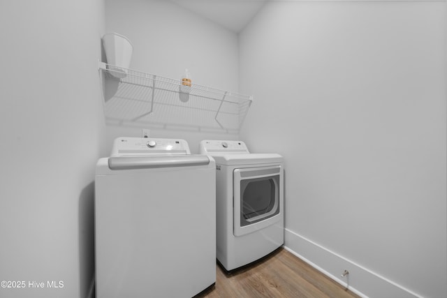7801 Harrier Cir, Leland, NC 28451 - clothes washing area with baseboards, wood finished floors, washing machine and dryer, and laundry area