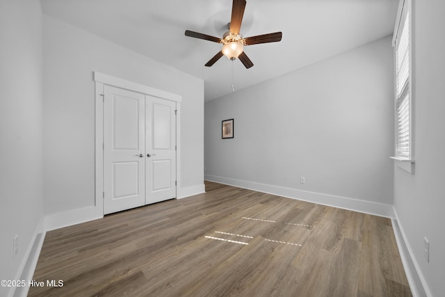 7801 Harrier Cir, Leland, NC 28451 - unfurnished bedroom with a closet, baseboards, and wood finished floors