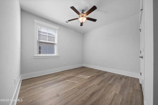 7801 Harrier Cir, Leland, NC 28451 - empty room featuring wood finished floors, baseboards, a ceiling fan, and visible vents