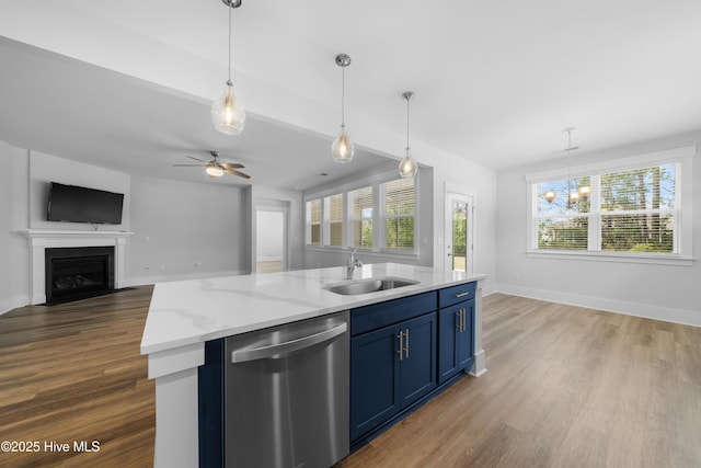 7801 Harrier Cir, Leland, NC 28451 - kitchen featuring open floor plan, dark wood-style floors, blue cabinetry, stainless steel dishwasher, and a sink
