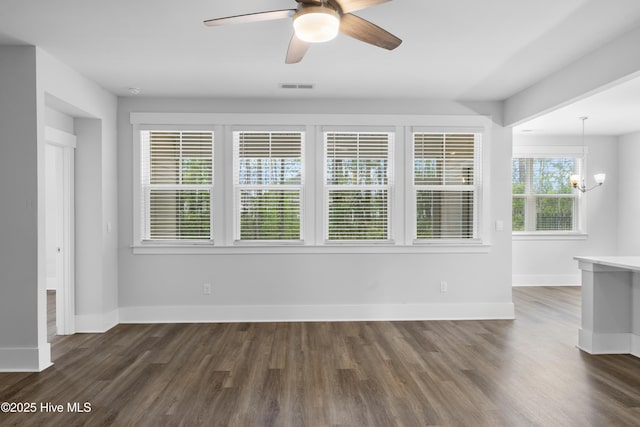 7801 Harrier Cir, Leland, NC 28451 - interior space with visible vents, baseboards, ceiling fan with notable chandelier, and dark wood-style floors