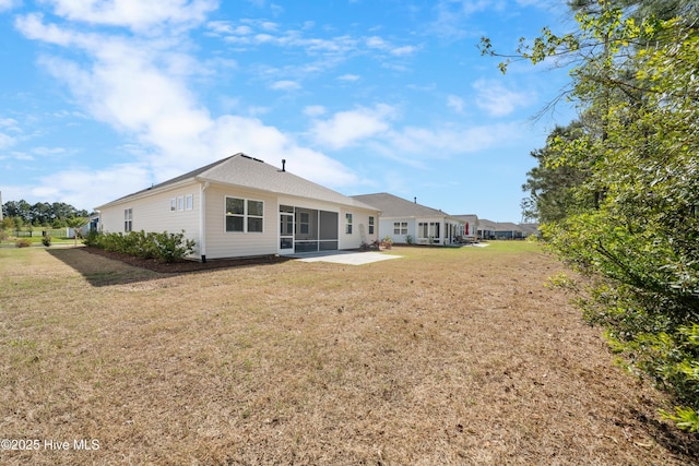 7801 Harrier Cir, Leland, NC 28451 - rear view of house with a yard, a patio, and a sunroom