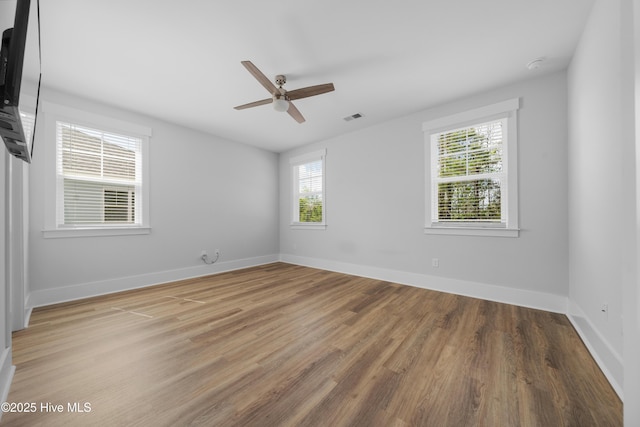 7801 Harrier Cir, Leland, NC 28451 - unfurnished room with visible vents, a wealth of natural light, light wood-type flooring, and ceiling fan
