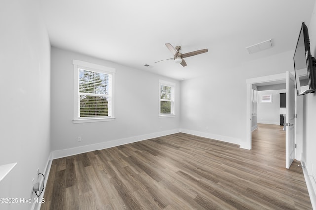 7801 Harrier Cir, Leland, NC 28451 - unfurnished room featuring wood finished floors, baseboards, a ceiling fan, and visible vents