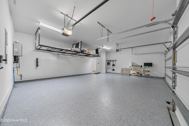 7801 Harrier Cir, Leland, NC 28451 - garage featuring baseboards, tankless water heater, and a garage door opener