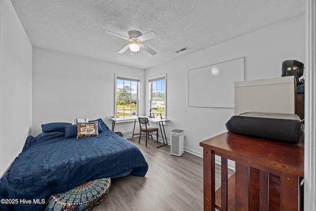 106 Hardin Dr, Maysville, NC 28555 - bedroom with wood finished floors, a textured ceiling, baseboards, and a ceiling fan