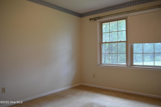 carpeted empty room with baseboards