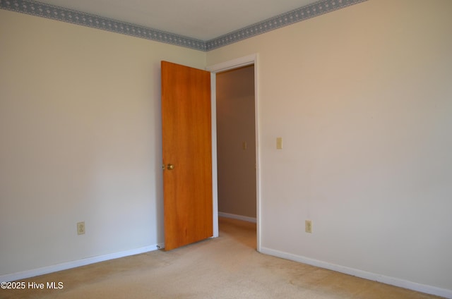 unfurnished room with carpet floors and baseboards