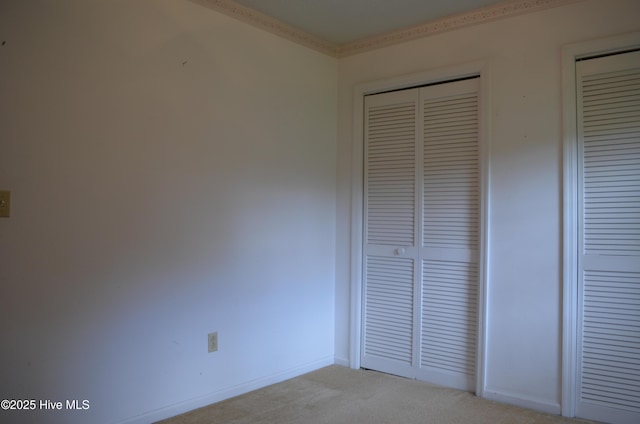 unfurnished bedroom featuring carpet and baseboards
