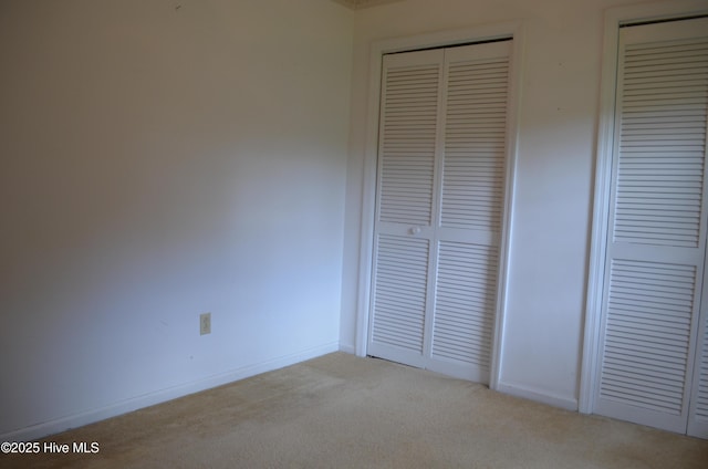unfurnished bedroom featuring baseboards and carpet floors