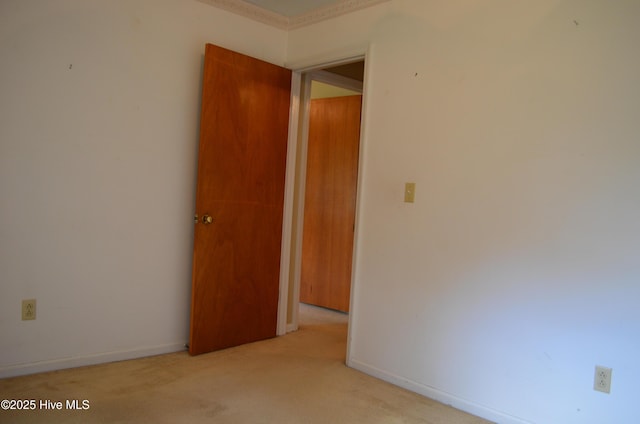 empty room featuring carpet flooring and baseboards