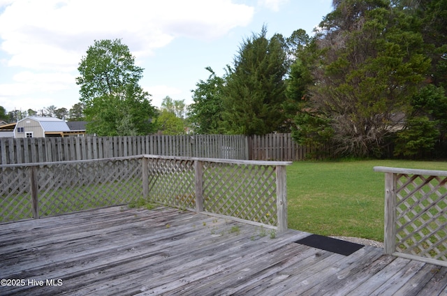 deck featuring fence and a lawn