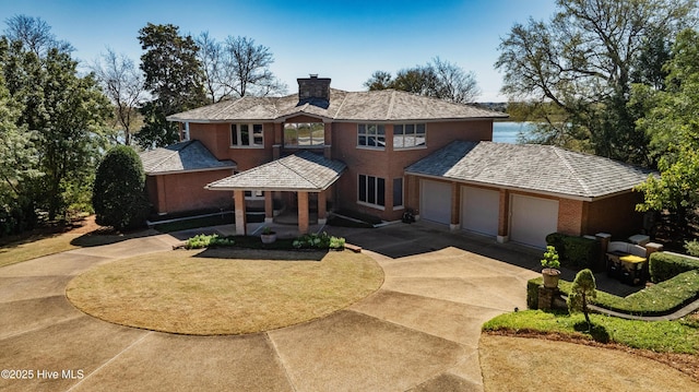 1409 Landfall Dr, Wilmington, NC 28405 - traditional home featuring driveway, a chimney, an attached garage, and a porch