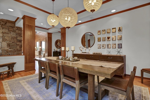 1409 Landfall Dr, Wilmington, NC 28405 - dining area with ornate columns, a chandelier, crown molding, light wood-type flooring, and recessed lighting