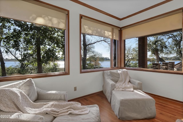 1409 Landfall Dr, Wilmington, NC 28405 - sitting room featuring a water view, baseboards, wood finished floors, and ornamental molding