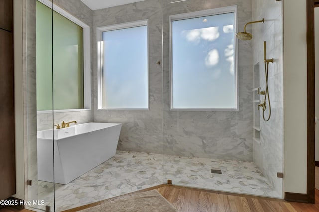1409 Landfall Dr, Wilmington, NC 28405 - bathroom featuring tiled shower, healthy amount of natural light, a soaking tub, and wood finished floors