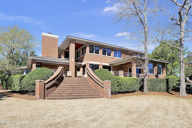 1409 Landfall Dr, Wilmington, NC 28405 - mid-century modern home featuring a chimney and stairway
