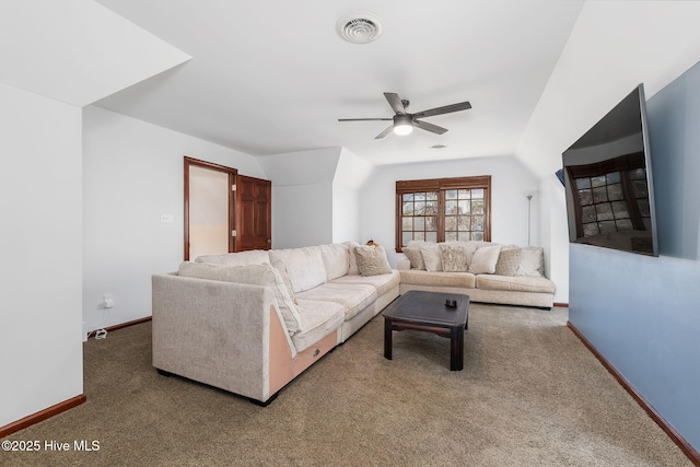 living area with visible vents, carpet floors, baseboards, and ceiling fan