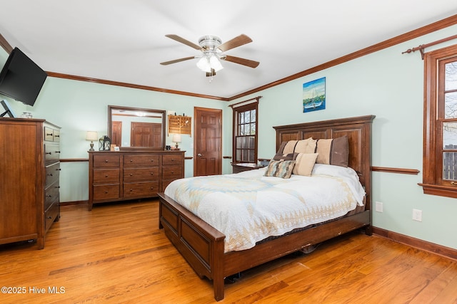 bedroom with light wood-style flooring, baseboards, multiple windows, and crown molding