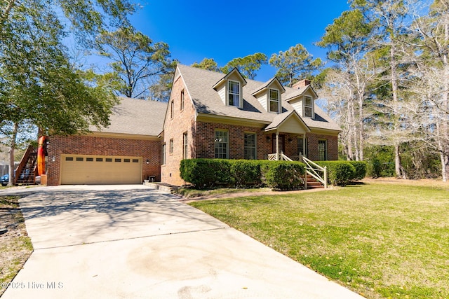 cape cod house with a front yard, a garage, a chimney, brick siding, and driveway