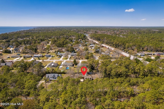 birds eye view of property with a view of trees and a residential view