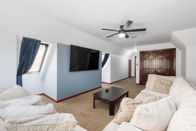 living room featuring baseboards, vaulted ceiling, a ceiling fan, and carpet floors