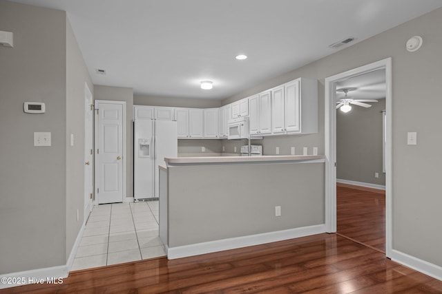 424 Commerce Ave Unit B, Morehead City, NC 28557 - kitchen featuring white cabinets, ceiling fan, visible vents, white appliances, and a peninsula