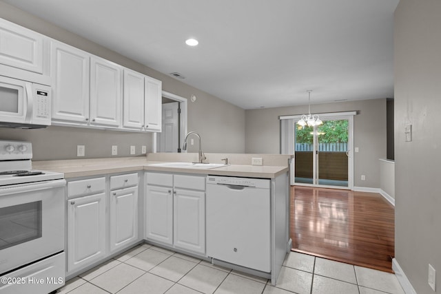424 Commerce Ave Unit B, Morehead City, NC 28557 - kitchen with light countertops, a sink, white cabinets, and white appliances