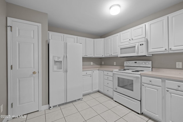 424 Commerce Ave Unit B, Morehead City, NC 28557 - kitchen featuring light tile patterned floors, white cabinetry, white appliances, and light countertops