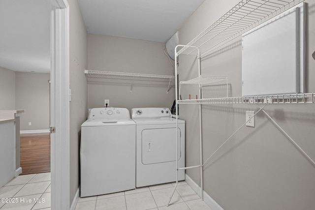 424 Commerce Ave Unit B, Morehead City, NC 28557 - washroom with washer and clothes dryer, baseboards, light tile patterned flooring, and laundry area
